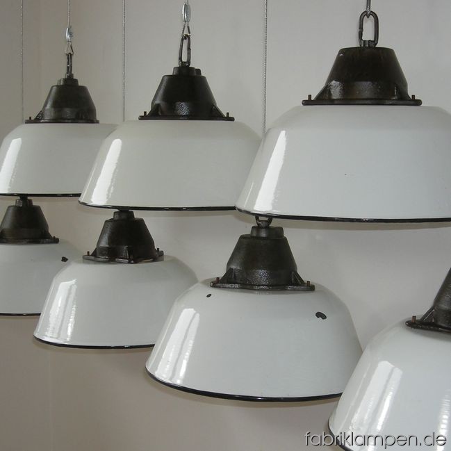 Industrial lamps with white enameled shades. Casted iron parts with wire rope suspension. Casted iron parts are cleaned and colorless varnished. Total height: as you wish (included in price up to 3 m). Height lamp ca. 23 cm (9 inches), diameter of the lamp ca. 36 cm (14,2 inches).