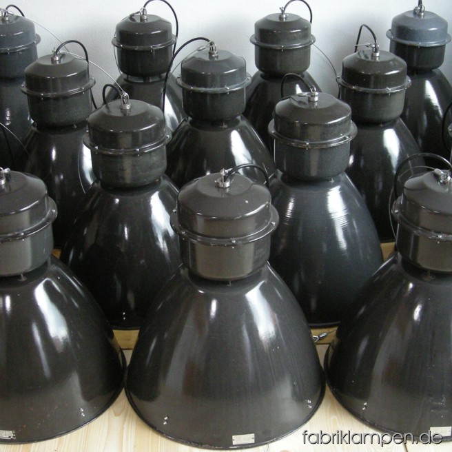 Big industrial lamps. Material: black (grayish) enameled sheet. The lamps are cleaned and newly electrified, with E27 sockets. Total height: ca. 62 cm (24,4 inches). Diameter of the shade ca. 53 cm (21 inches).