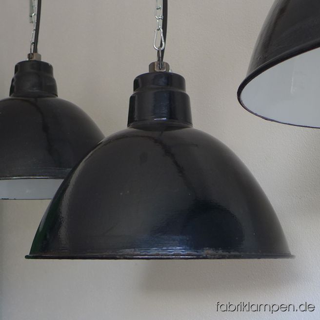 Old black enamel LBD loft lamp, produced by Leuchtenbau Dresden. The lamps have the typical traces of usage and age. Material: black (inside white) enameled steel sheet. Newly electrified, with E27 ceramic sockets. Height of the lamp ca. 29 cm (11,4 inches), diameter of the shade ca. 42 cm (16,5 inches).