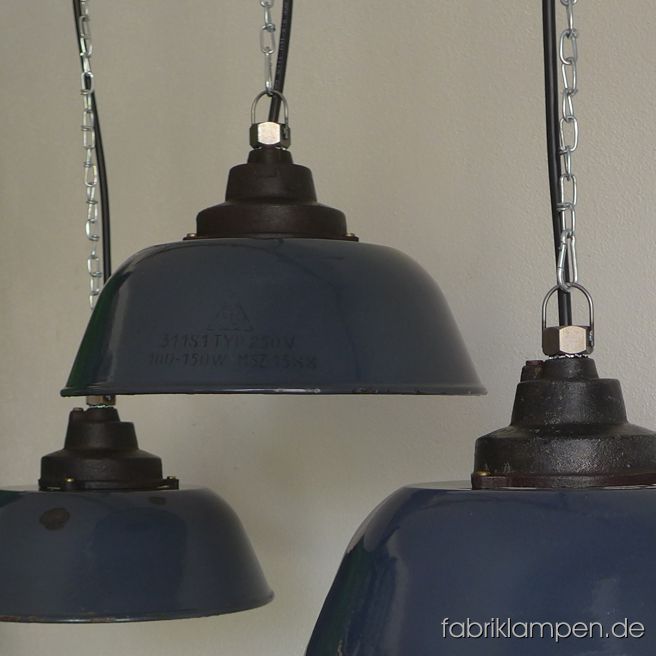 Alte blaue Emaille Fabriklampe mit Gusseisernem Oberteil und Emailleschirm mit Herstellerangaben (EKA). Aktuell haben wir 8 Exemplare auf Lager. Die Leuchten haben die Spuren der vergangenen Jahrzehnte (kleine  Abplatzer, Roststellen, Kratzer, Verfärbungen and Co. – wir haben die alle behandelt). Sie sind gereinigt und neu elektrifiziert, ausgestattet mit neuen E27 Porzellanfassungen. Material: dunkelblau (innen weiß) emailliertes Blech, gusseisernes Oberteil. Die Lampen werden mit 2 meter Kabel (andere Länge ist natürlich möglich), mit Aufhängeöse, ohne Aufhängung geliefert. Textilkabel bzw. Kettenaufhängung sind gegen Aufpreis möglich. Höhe der Lampen ca. 20,5 cm, Durchmesser Schirm 36 cm.