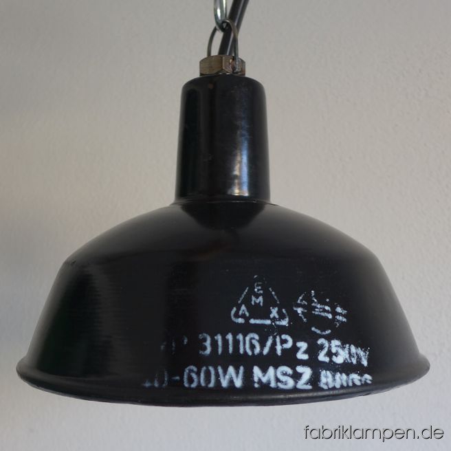 Schöne kleine schwarze Emaille Industrielampe mit weißer Aufschrift. Material: schwarz, innen weiß emailliertes Stahlblech. Die Lampen haben die üblichen Spuren der vergangenen Jahrzehnte (Abplatzer, Kratzer, Verfärbungen, kleinere Roststellen, und Co.). Wir haben diese alle behandelt. Die Leuchten sind gereinigt und neu elektrifiziert (mit E27 Porzellanfassungen). Die Lampen werden mit Aufhängeöse und 2 Meter Kabel geliefert (andere Längen sind natürlich möglich), auf Wunsch können sie mit Textilkabel, Ketten- oder Stahlrohr-Aufhängung ausgestattet werden (gegen Aufpreis). 
Die Abmessungen: Durchmesser Lampe 26 cm, Höhe 18 cm. 