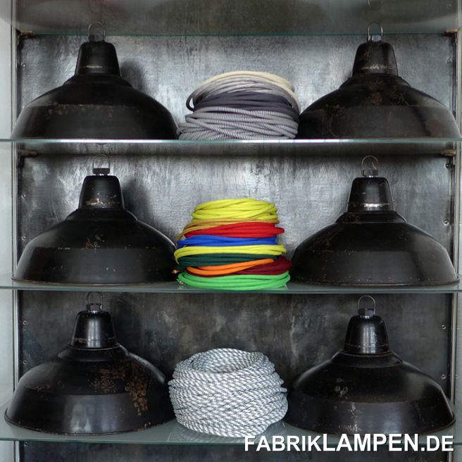 Alte schwarze Fabriklampen aus den 1930er Jahren. Vor kurzem haben wir aus dem Dachboden einer alten Fabrik insgesamt 200 Lampen gekauft, ein Teil davon (140 Stück) sind diese Lampen. Auf dem letzten Bild in der Galerie sind die alten Fabriklampen im Fundzustand zu sehen (in den hinteren drei Reihen Schirme in der größeren Ausführung). 

Die alte Emaillelampen stammen aus deutscher Herstellung. Besonders bei diesen Industrielampen ist, dass sie nicht emailliert, sondern lackiert sind. Manche Hersteller boten die Lampen auch lackiert an, da diese Ausführung einen günstigeren Preis ermöglichte. Oft bei demselben Modell, da das Blechschild dasselbe war, als bei der emaillierten Variante. 

Diese schönen Fabriklampen haben die starken Spuren der vergangenen Jahrzehnte wie Abplatzer, Roststellen, Kratzer, Verfärbungen und Co. Damit ist jede einzelne Lampe ein Unikat. Mit den verwitterten Innenseiten entstehen einzigartige Lichteffekte und die vergilbte/verrostete Oberfläche erzeugt ein besonders warmes Licht. 

Sie sind restauriert: gereinigt, konserviert und neu elektrifiziert, mit neuen E27 Keramikfassungen.

Material: schwarz (innen weiß) lackiertes Stahlblech. 

Die Abmessungen: 
Kleinere Variante (wie abgebildet): Höhe der Lampen ca. 20 cm (ohne Aufhängeöse), Durchmesser ca. 36 cm.  

Größere Variante: Höhe der Lampen ca. 23,5 cm (ohne Aufhängeöse), Durchmesser ca. 40,5 cm.

Die alten Fabriklampen werden mit 2 Meter Textilkabel Farbe Ihrer Wahl (andere Längen sind natürlich möglich) und massiver Aufhängeöse für die sichere Aufhängung geliefert. Gegen Aufpreis können die Lampen auch mit Ketten- oder Stahlrohr-Aufhängung geliefert werden. Baldachine können wir auch anbieten. 